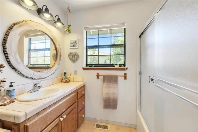 an aerial view of a house with a yard and lake view