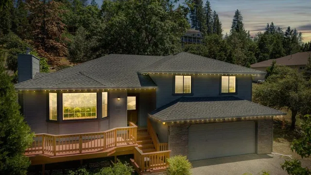 an aerial view of a house with garden space and a street view