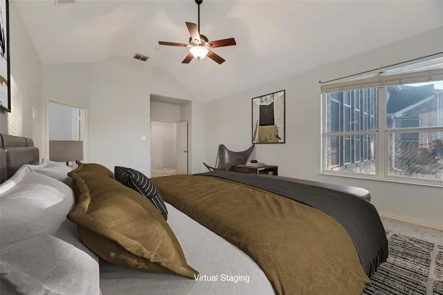 a spacious bedroom with a bed and window