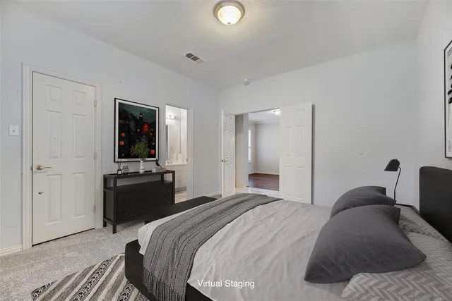 a bedroom with a bed and a television