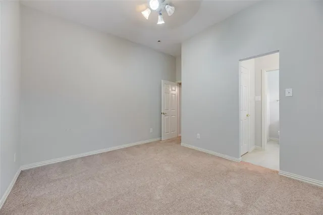 an empty room with a chandelier fan