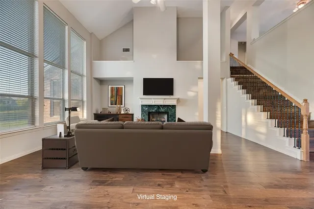 a living room with furniture a flat screen tv and a fireplace