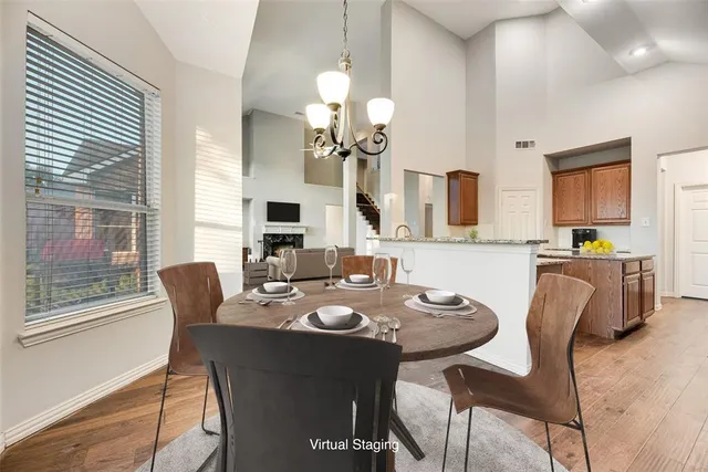 a view of a dining room with furniture and a chandelier