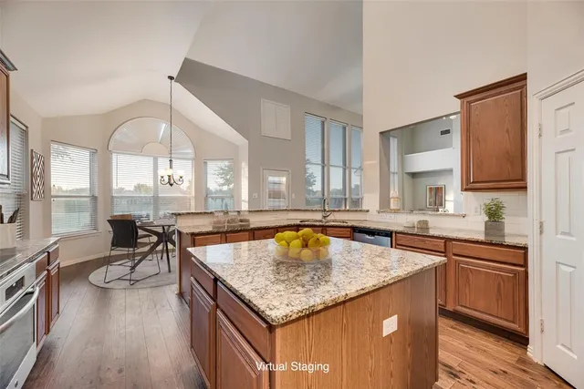 a kitchen with a stove a sink dishwasher and cabinets with wooden floor