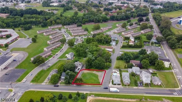 an aerial view of residential houses with outdoor space and swimming pool