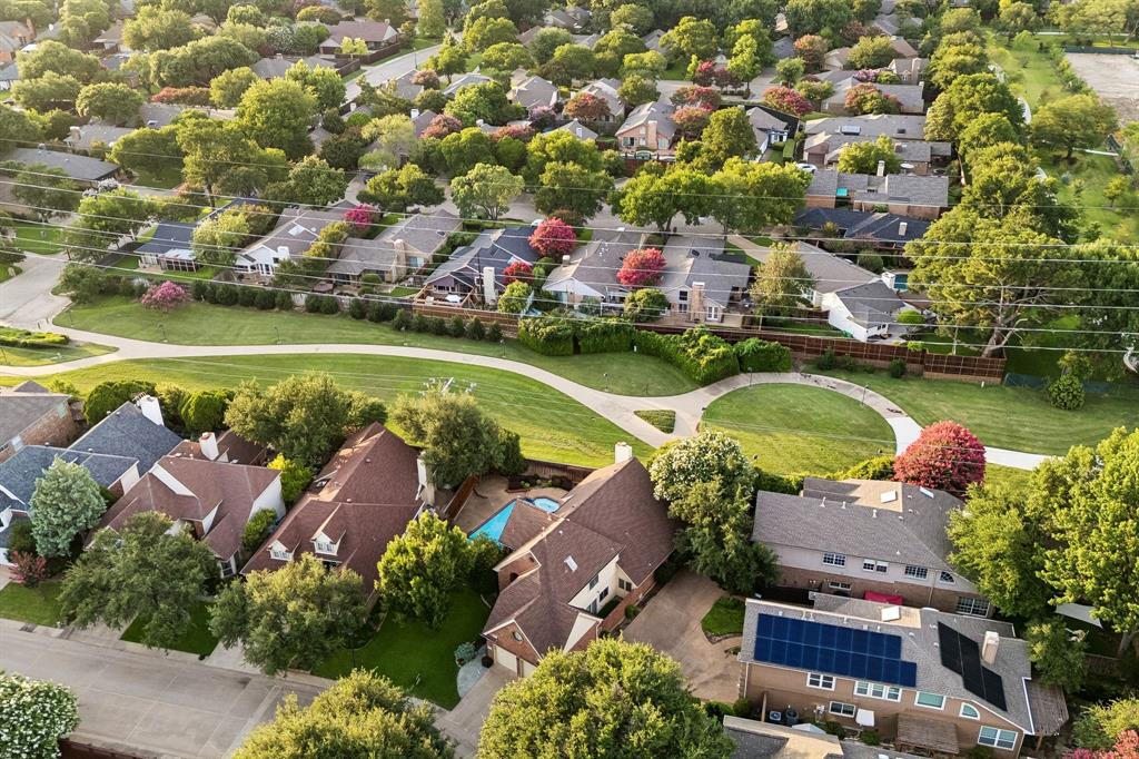 4115 Rive Lane Addison, TX 75001 - Photo 23 of 25 Expansive residential community featuring mature trees, a curvilinear green space, and varied home styles