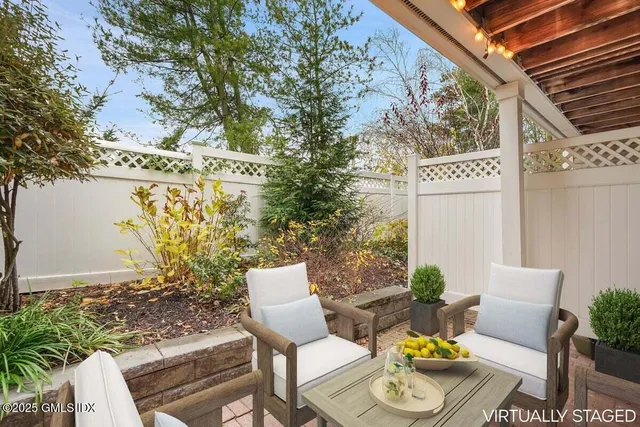 a view of an empty room with wooden floor and a fireplace