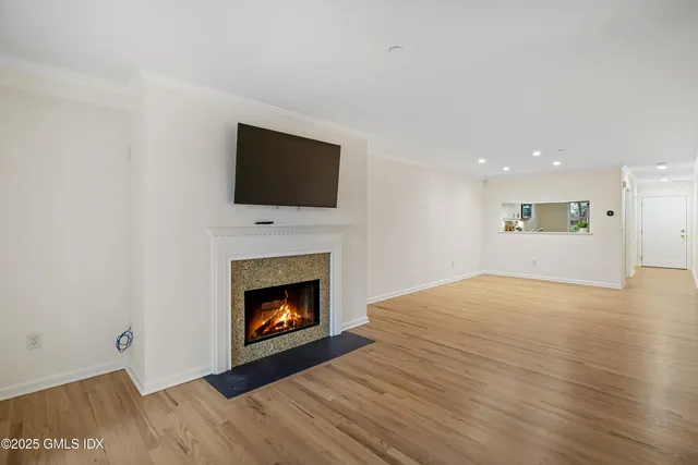 a kitchen with granite countertop cabinets stainless steel appliances and a wooden floor