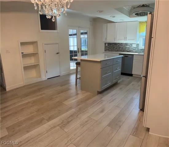 a kitchen with stainless steel appliances granite countertop a stove and a refrigerator
