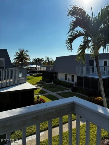 a view of balcony with two chairs and a potted plant