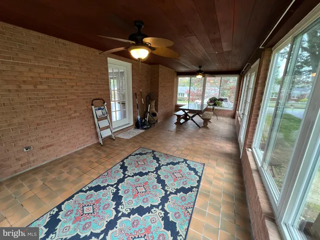 a bathroom with a sink a toilet a shower and a window