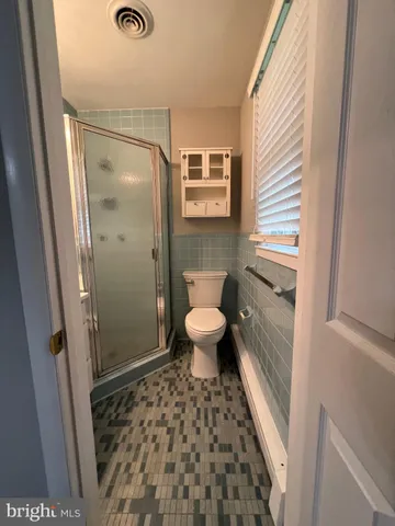 a dining room with furniture and a floor to ceiling window