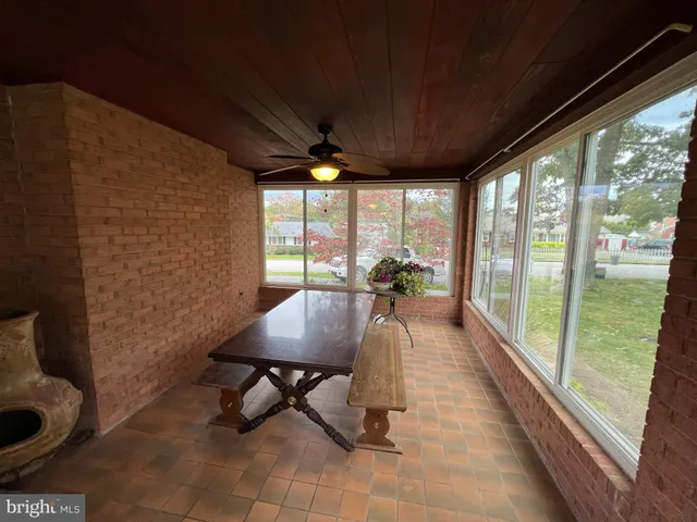 a living room with patio furniture and a large window
