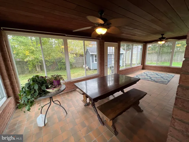 a large white kitchen with kitchen island a stove a sink and a refrigerator