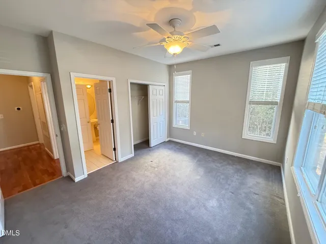 an empty room with windows and entrance