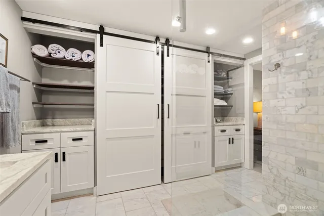 a kitchen with white cabinets and refrigerator