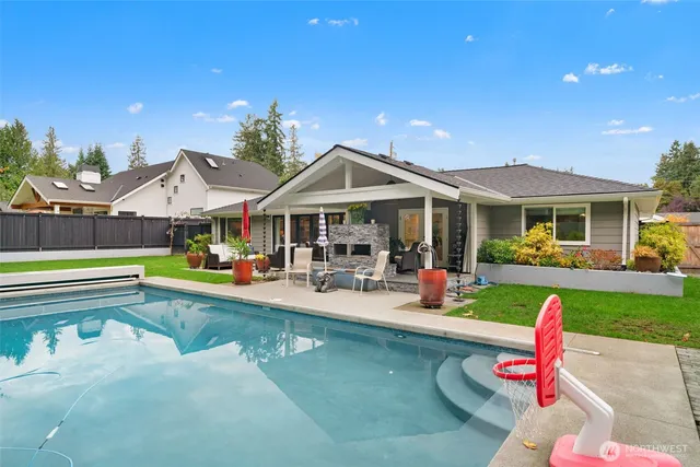 a view of a house with swimming pool and a yard
