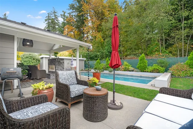 a view of a chairs and table in patio with a fire pit