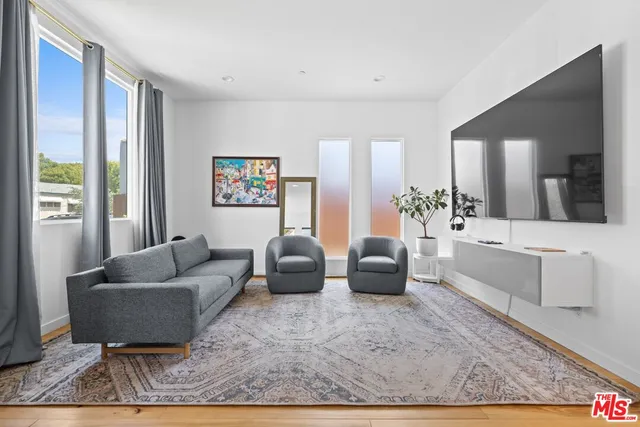 a living room with furniture and a rug