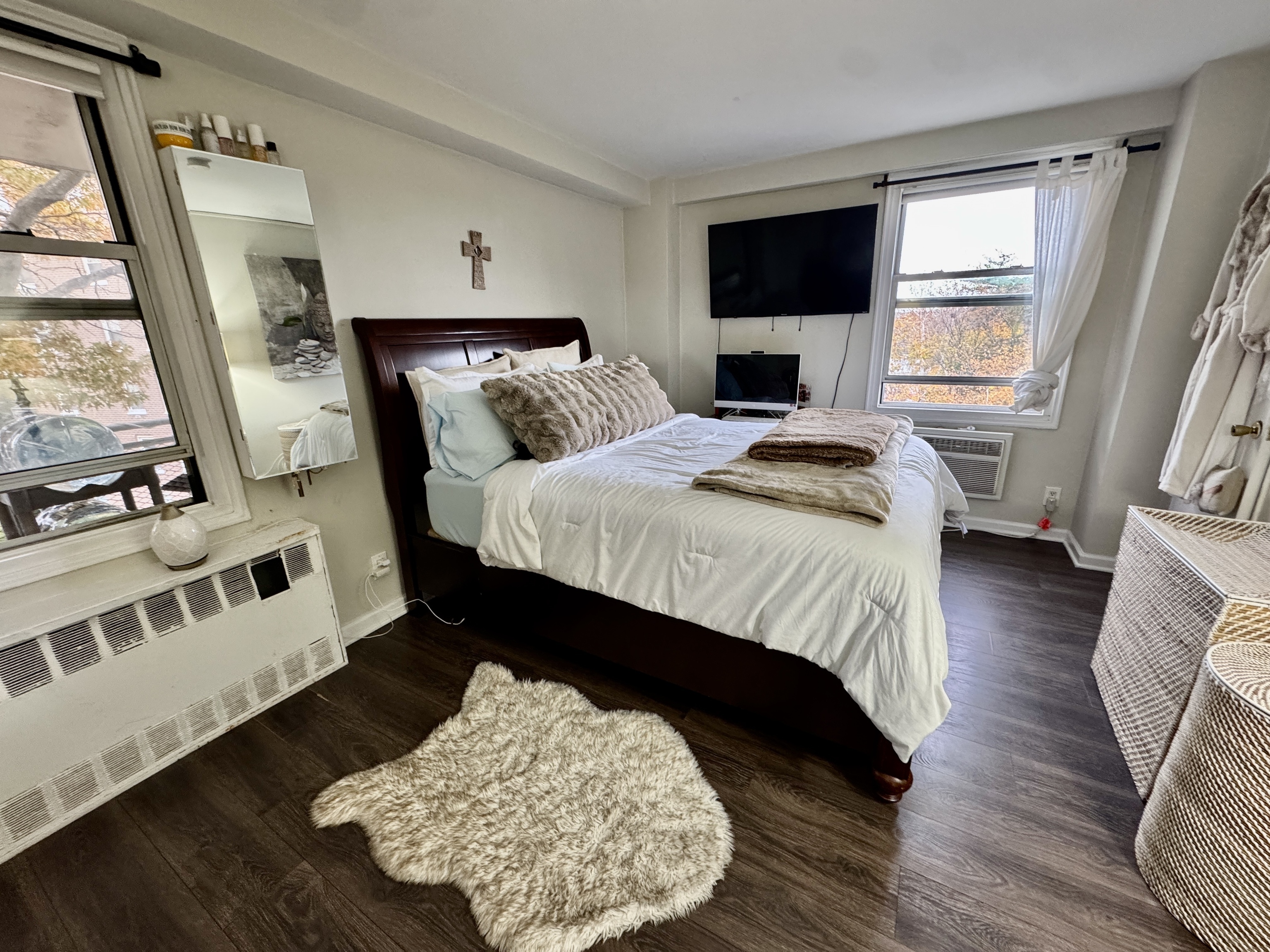 71 Strawberry Hill Avenue, Unit 421 Stamford, CT 06902 - Photo 18 of 31 a bedroom with a bed lamps and wooden floor