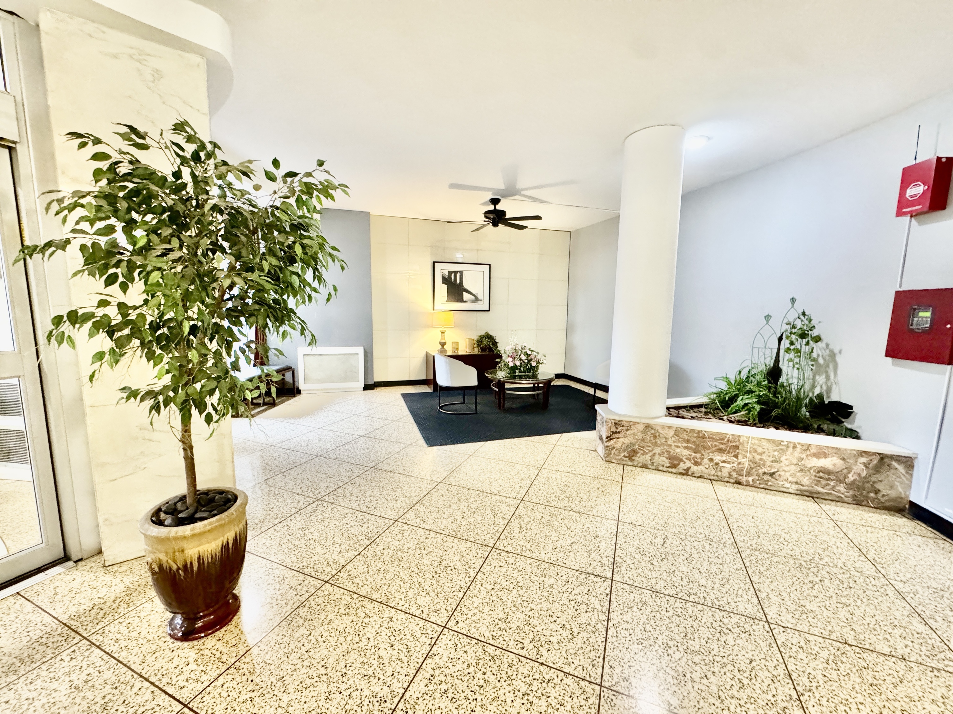 71 Strawberry Hill Avenue, Unit 421 Stamford, CT 06902 - Photo 5 of 31 a living room with a garden and a potted plant