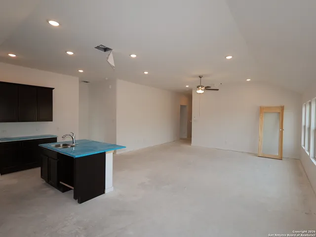 a living room with kitchen island furniture and a flat screen tv