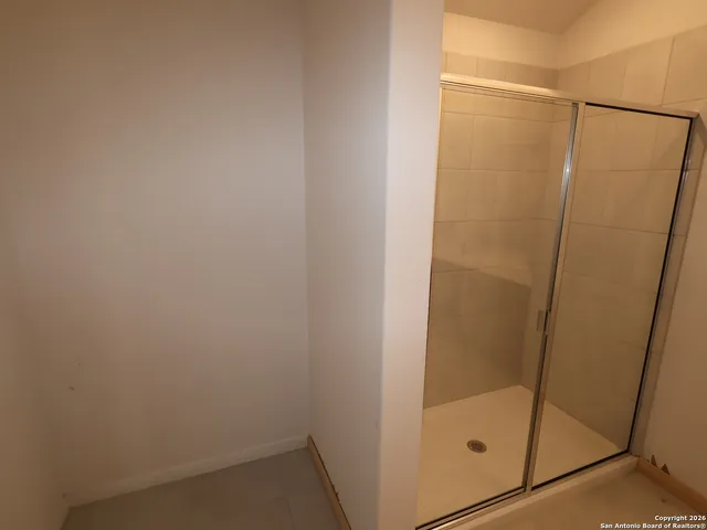 a bathroom with a glass shower door