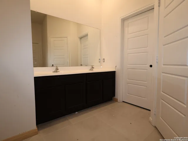a kitchen with a sink and a mirror