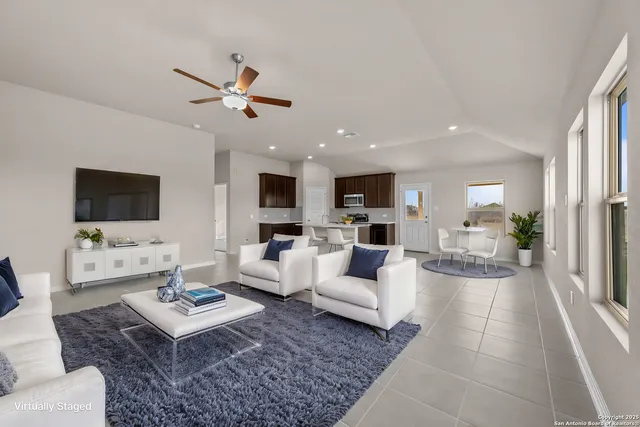 a living room with furniture a rug and a flat screen tv