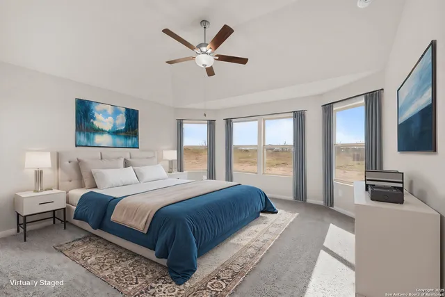 a spacious bedroom with a large bed and a flat screen tv