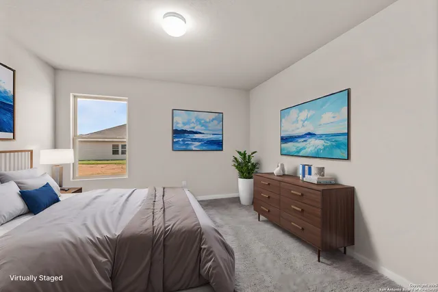 a bed room with a bed and a painting on the wall