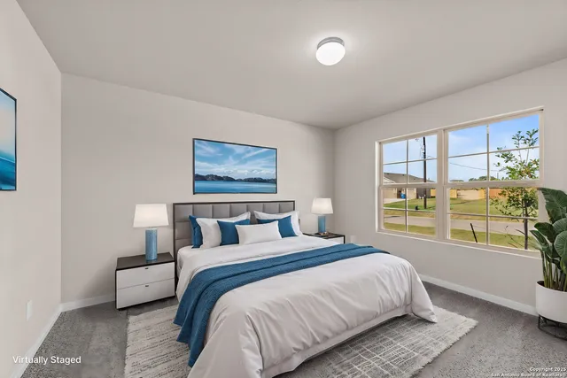 a bed room with a bed and a large window