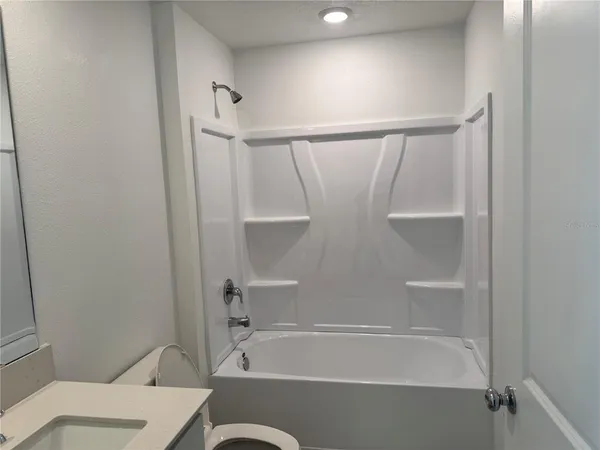 a bathroom with a bathtub and a toilet