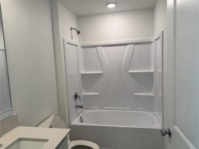 a bathroom with a bathtub and a toilet