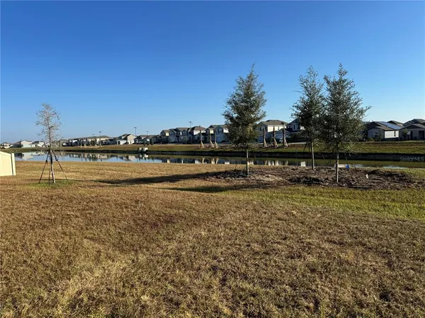a view of a lake with houses in the back