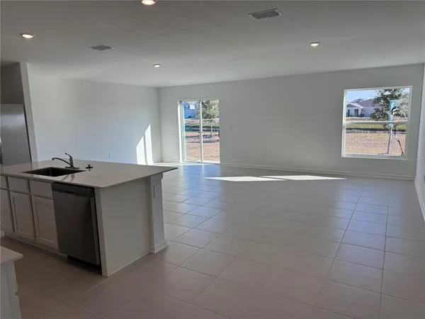 a kitchen with a sink cabinets and a window