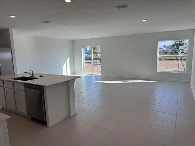 a kitchen with a sink cabinets and a window