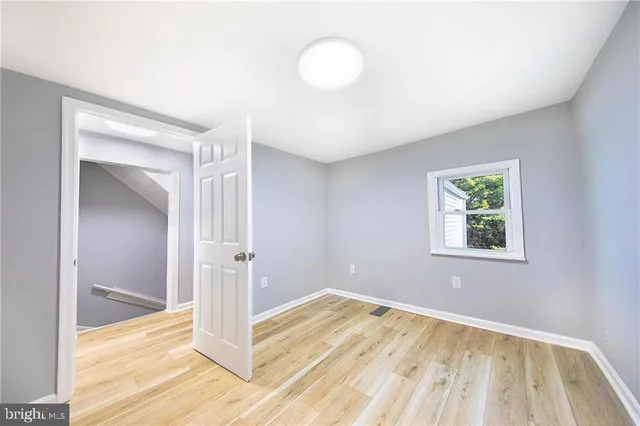 a view of a room with wooden floor and window