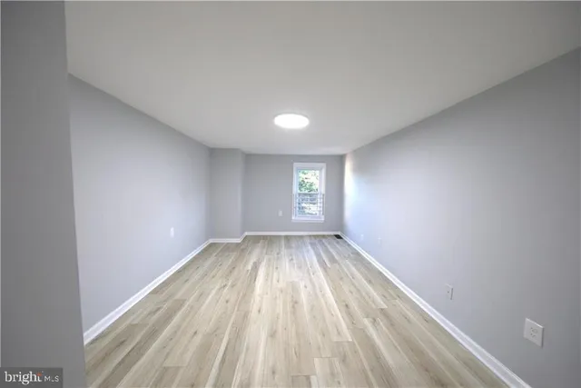 a view of room with window and hardwood floor