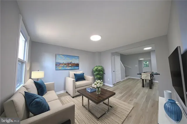 a living room with furniture and a flat screen tv