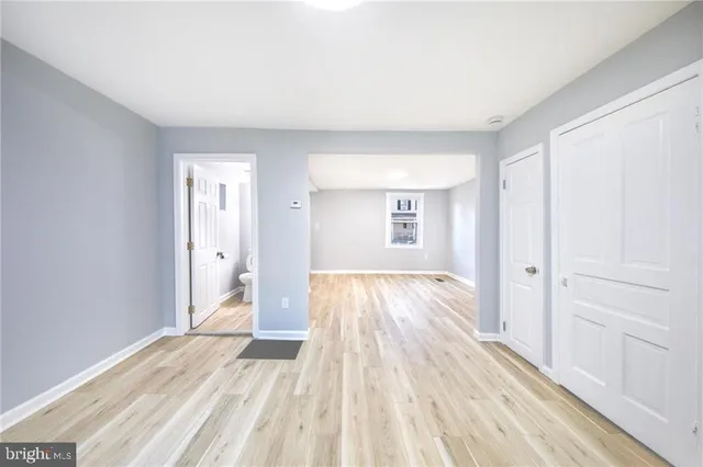 a view of a room with wooden floor and bathroom
