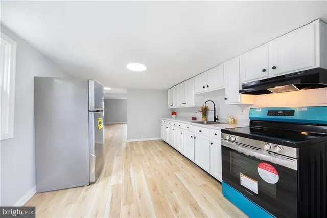 a kitchen with granite countertop a sink and a stove top oven