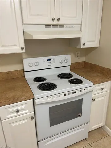 a stove top oven sitting inside of a kitchen