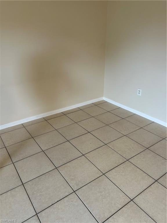 3325 Airport-Pulling Road Naples, FL 34105 - Photo 3 of 9 Spare room featuring baseboards and tile patterned floors
