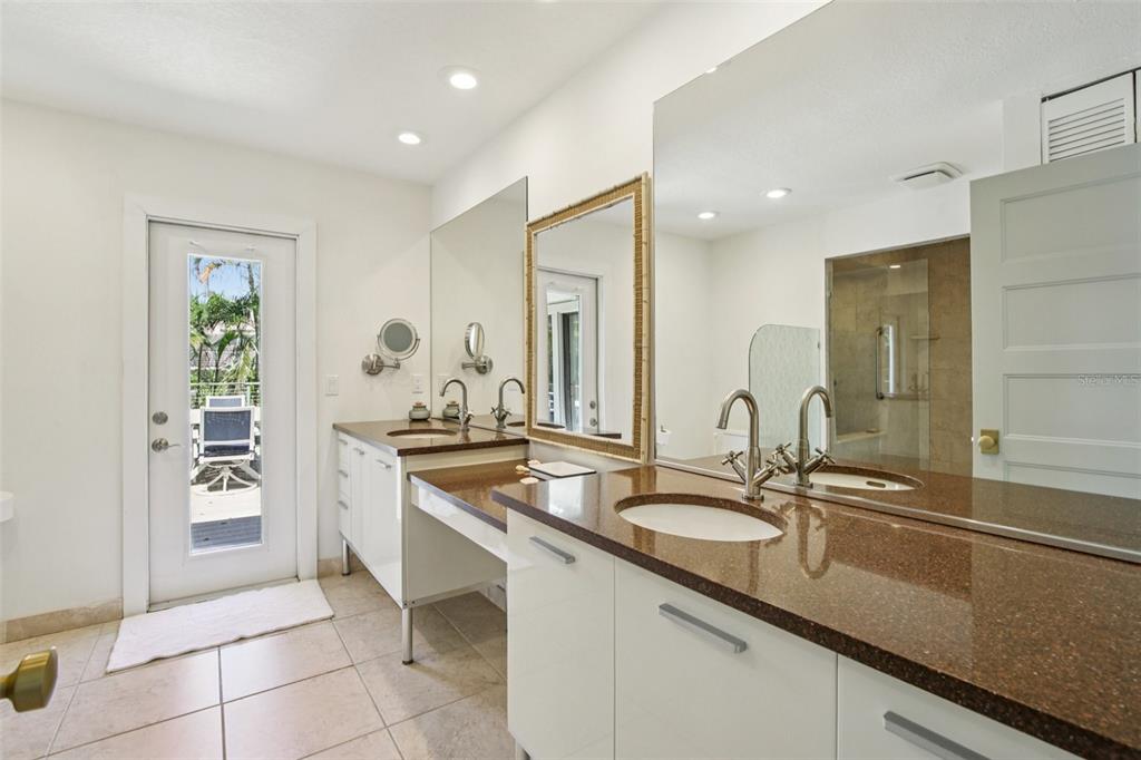 3390 Bayou Sound Longboat Key, FL 34228 - Photo 8 of 59 a bathroom with a sink and a mirror