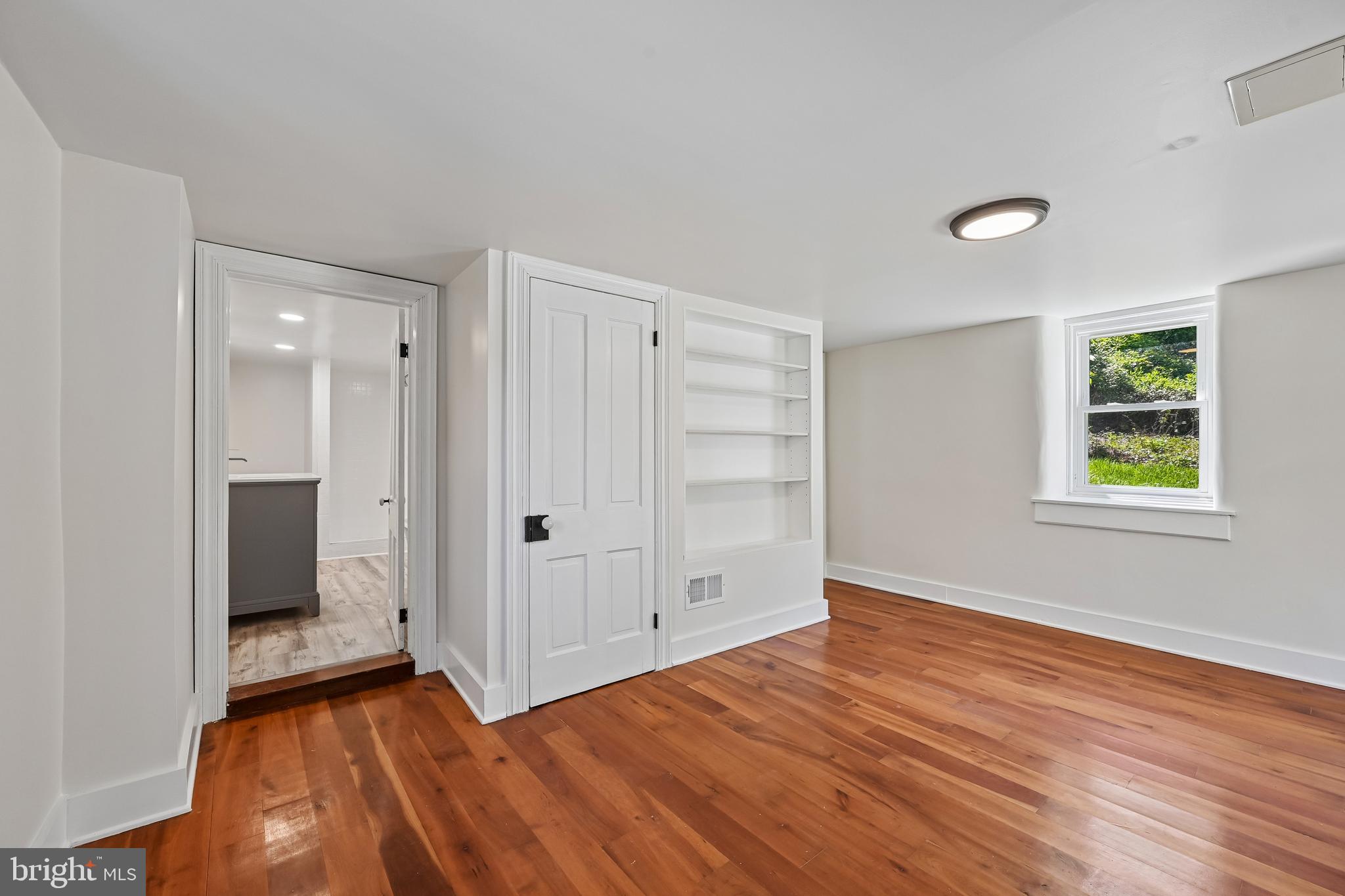 5702 Falls Road Baltimore, MD 21209 - Photo 11 of 49 a view of a room with wooden floor and windows
