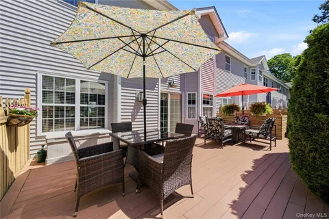 a view of a patio with a table and chairs under an umbrella