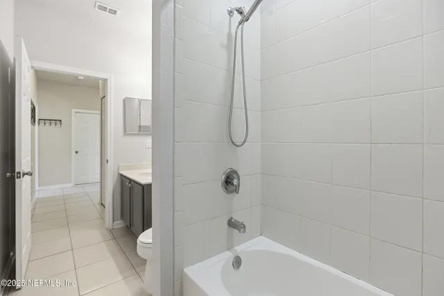 a bathroom with a bathtub a toilet and a shower