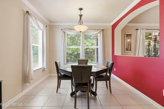 a dining room with furniture and window