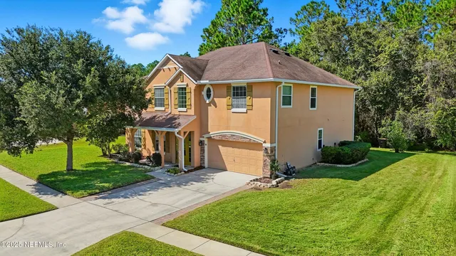 a front view of house with yard and green space